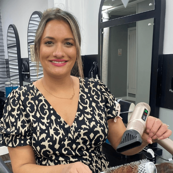Aesha styling a clients hair at Hair Pro UK