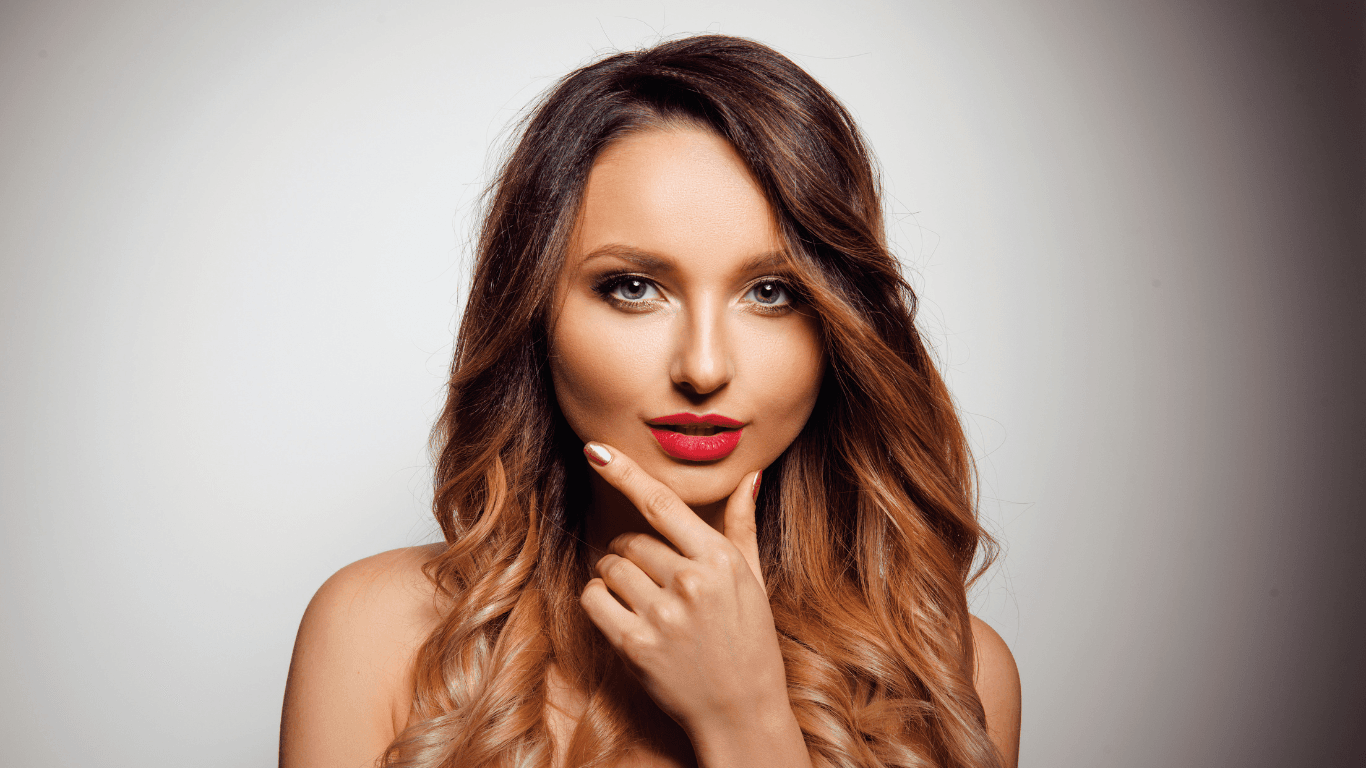 Woman with beautifully blended caramel balayage on dark hair, showcasing expert balayage hair colouring by Hair Pro UK in Bexhill-on-Sea, East Sussex.