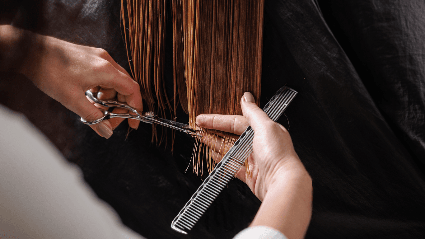 Close-up of a stylist giving a precision haircut with scissors and comb, showcasing expert gender-neutral hair styling at Hair Pro UK in Bexhill-on-Sea.