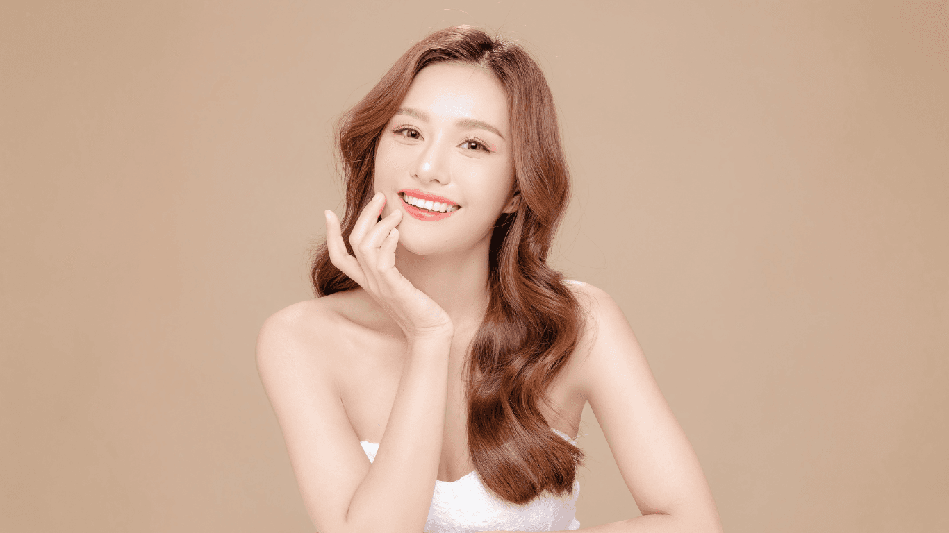 Smiling woman with beautifully styled, long wavy hair, showcasing the expert cut and finish services for longer hair at Hair Pro UK in Bexhill-on-Sea, East Sussex.