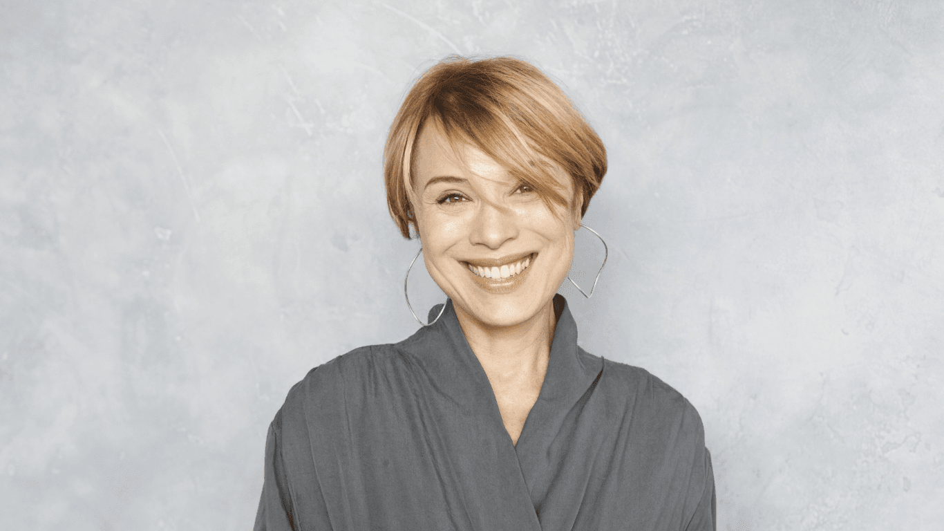 Smiling woman with a chic, professionally cut short hairstyle, showcasing the expert cut and finish services available at Hair Pro UK in Bexhill-on-Sea, East Sussex.