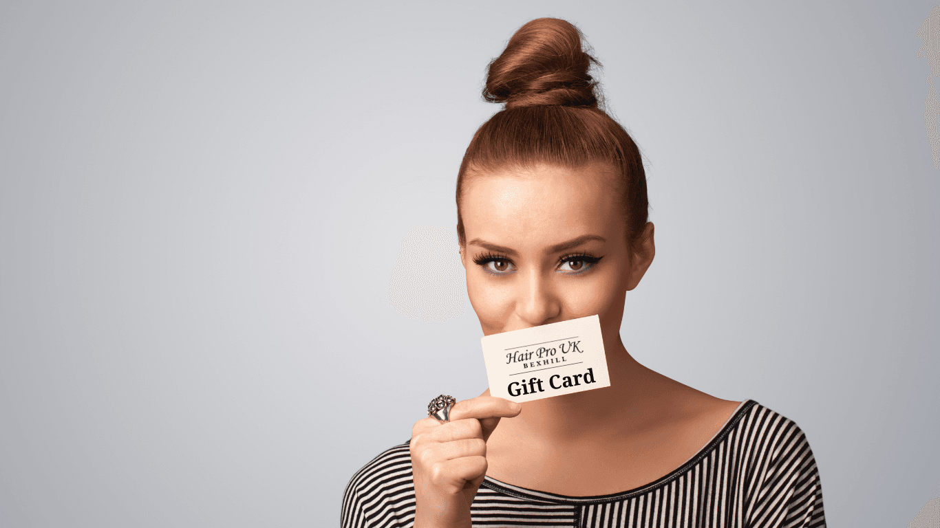 Woman holding a Hair Pro UK e-Gift Card at the Bexhill-on-Sea salon, offering luxury hairdressing gift experiences in East Sussex.