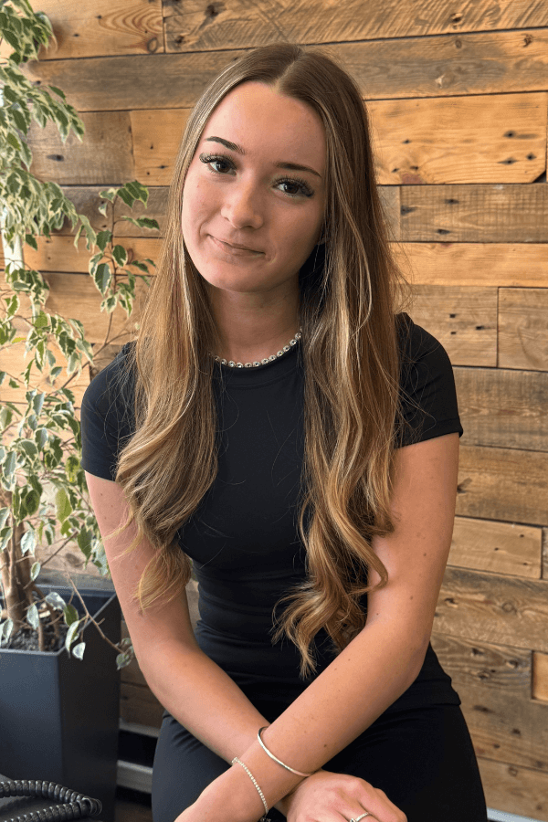 Summer, Graduate Stylist at Hair Pro UK in Bexhill-on-Sea, applying professional care at the backwash during a colour appointment.